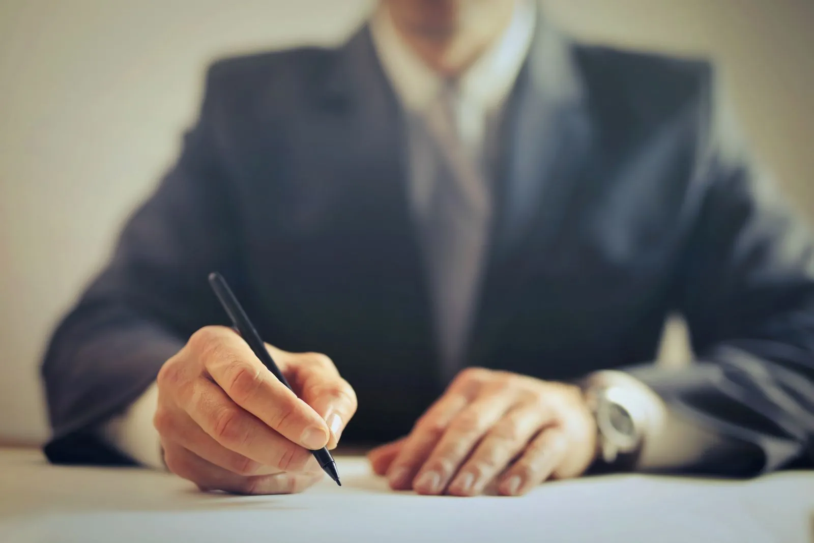 Businessman signing a contract at an office desk
